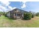 Enclosed patio area with pergola, lush green lawn and plenty of backyard space at 1709 Nodding Thistle Dr, New Port Richey, FL 34655