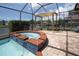 Relaxing poolside view featuring a covered pergola and spa overlooking a tranquil lake at 1709 Nodding Thistle Dr, New Port Richey, FL 34655