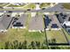 Aerial view of houses in a suburban neighborhood with green lawns and solar panels on some roofs on a sunny day at 1957 Fan Aloe Way, Ruskin, FL 33570