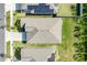 Aerial view of a single-Gathering home, showcasing its roof, driveway, landscaping, and proximity to neighboring properties at 1957 Fan Aloe Way, Ruskin, FL 33570