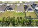 Aerial view of a residential area with single-Gathering homes, green lawns, and a well-maintained street on a clear day at 1957 Fan Aloe Way, Ruskin, FL 33570