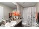Well-lit bathroom featuring a tub with shower, granite vanity, and contemporary accents at 1957 Fan Aloe Way, Ruskin, FL 33570