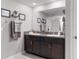 Bathroom featuring a double vanity with granite countertops, a large mirror, and modern fixtures at 1957 Fan Aloe Way, Ruskin, FL 33570