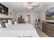 Bright bedroom featuring a king-size bed, artwork, and bedside tables at 1957 Fan Aloe Way, Ruskin, FL 33570
