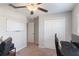 This carpeted bedroom features a ceiling fan, closet, desk and whiteboard, offering flexibility at 1957 Fan Aloe Way, Ruskin, FL 33570