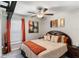 Cozy bedroom features carpet, ceiling fan, bright window, warm accents, and charming artwork at 1957 Fan Aloe Way, Ruskin, FL 33570