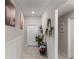 Inviting entryway featuring tiled floors, decorative wall art, and stylish storage at 1957 Fan Aloe Way, Ruskin, FL 33570