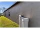Exterior side view of home, featuring a water softener at 1957 Fan Aloe Way, Ruskin, FL 33570