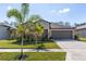 Charming single Gathering home featuring a well-manicured lawn and two car garage at 1957 Fan Aloe Way, Ruskin, FL 33570