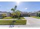 Charming single Gathering home featuring a well-manicured lawn and two car garage at 1957 Fan Aloe Way, Ruskin, FL 33570