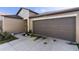 Close up of home featuring a two car garage and verdant landscaping at 1957 Fan Aloe Way, Ruskin, FL 33570
