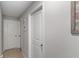 Hallway with neutral walls, neutral tile flooring, and a wall hanging at 1957 Fan Aloe Way, Ruskin, FL 33570
