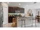 Modern kitchen features granite countertops, stainless steel appliances, and a functional island with bar seating at 1957 Fan Aloe Way, Ruskin, FL 33570