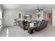 Bright living room featuring neutral tones, tile flooring, and comfortable leather furniture arrangement at 1957 Fan Aloe Way, Ruskin, FL 33570