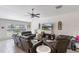 Spacious living room with a ceiling fan, a brick accent wall, and comfortable leather seating at 1957 Fan Aloe Way, Ruskin, FL 33570