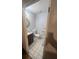 Simple bathroom with tiled floor, vanity with sink, and toilet at 2335 Canfield Dr, Spring Hill, FL 34609