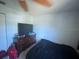 Bedroom featuring a ceiling fan and a dresser with a TV at 2335 Canfield Dr, Spring Hill, FL 34609