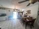 Cozy dining area with dark wood furniture and a view of the outside through sliding glass doors at 2335 Canfield Dr, Spring Hill, FL 34609