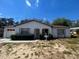 Cozy single-story home with a well-maintained exterior, featuring a white facade and attached garage at 2335 Canfield Dr, Spring Hill, FL 34609