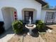 Charming front porch with a white fountain surrounded by lush greenery, offers a welcoming entry at 2335 Canfield Dr, Spring Hill, FL 34609