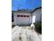 Attached garage features bright-red trim, ample driveway space, and extra storage at 2335 Canfield Dr, Spring Hill, FL 34609
