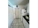 Galley kitchen featuring laminate countertops, white cabinets, and tiled floors at 2335 Canfield Dr, Spring Hill, FL 34609