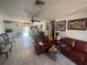 Open-concept living room and dining area with tiled floors and lots of natural light at 2335 Canfield Dr, Spring Hill, FL 34609