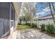 A small backyard featuring some trees and a white fence at 2506 W Ivy St, Tampa, FL 33607