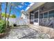 Small backyard featuring a paver patio, some trees and a screened-in lanai at 2506 W Ivy St, Tampa, FL 33607