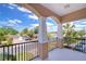 Balcony with decorative railings, columns, and a view of the neighborhood at 2506 W Ivy St, Tampa, FL 33607