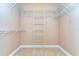 Empty walk-in closet with built-in shelving for optimal storage solutions at 2506 W Ivy St, Tampa, FL 33607