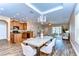 Bright open living room with wood floors, modern chandelier, and kitchen island at 2506 W Ivy St, Tampa, FL 33607