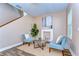 Cozy living room featuring a decorative fireplace, modern furniture, and a staircase at 2506 W Ivy St, Tampa, FL 33607