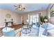 Bright living room with modern decor, wood floors, and a large sliding glass door to the patio at 2506 W Ivy St, Tampa, FL 33607
