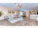 Spacious living room boasts hardwood floors, stylish furnishings, and an open floor plan flowing into the kitchen at 2506 W Ivy St, Tampa, FL 33607