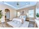 Comfortable main bedroom with neutral palette, tray ceiling, and wood-look flooring at 2506 W Ivy St, Tampa, FL 33607