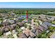 High aerial shot of home in a neighborhood with a pond and lush green landscaping at 2630 Milford Berry Ln, Tampa, FL 33618