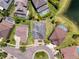 Aerial view of a home with a well-manicured lawn, surrounded by other homes and some with pools at 2630 Milford Berry Ln, Tampa, FL 33618