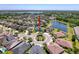 Stunning aerial view of home in a cul-de-sac, near a pond, with lush landscaping at 2630 Milford Berry Ln, Tampa, FL 33618