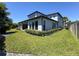 Large backyard with green grass and view of the home's patio at 2630 Milford Berry Ln, Tampa, FL 33618