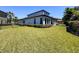 Spacious backyard with lush green grass and manicured hedges at 2630 Milford Berry Ln, Tampa, FL 33618