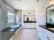 Bright bathroom showcasing dual sinks, glass shower, and relaxing soaking tub at 2630 Milford Berry Ln, Tampa, FL 33618
