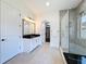 Bathroom featuring soaking tub, glass shower, vanity, and walk-in closet at 2630 Milford Berry Ln, Tampa, FL 33618