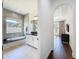 Bathroom with a tiled soaking tub and window, view through archway to bedroom at 2630 Milford Berry Ln, Tampa, FL 33618