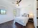 Inviting bedroom with hardwood floors, a ceiling fan, and large windows for plenty of sunlight at 2630 Milford Berry Ln, Tampa, FL 33618