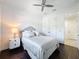 Cozy bedroom featuring a bed, bedside table, and a ceiling fan, complete with access to more living spaces at 2630 Milford Berry Ln, Tampa, FL 33618