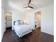 Bright bedroom featuring dark wood floors and walk-in closet with custom shelving at 2630 Milford Berry Ln, Tampa, FL 33618
