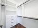 Walk-in closet with custom shelving and dark wood floors at 2630 Milford Berry Ln, Tampa, FL 33618