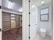 Walk-in closet and powder room with toilet and window at 2630 Milford Berry Ln, Tampa, FL 33618