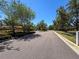Scenic community entrance showcasing lush landscaping and decorative iron gates at 2630 Milford Berry Ln, Tampa, FL 33618